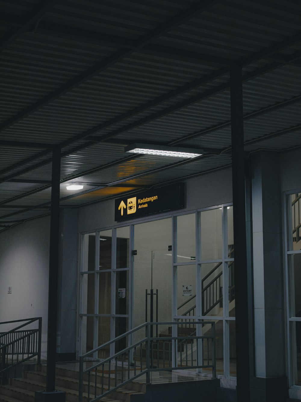 an empty building with a sign above the door