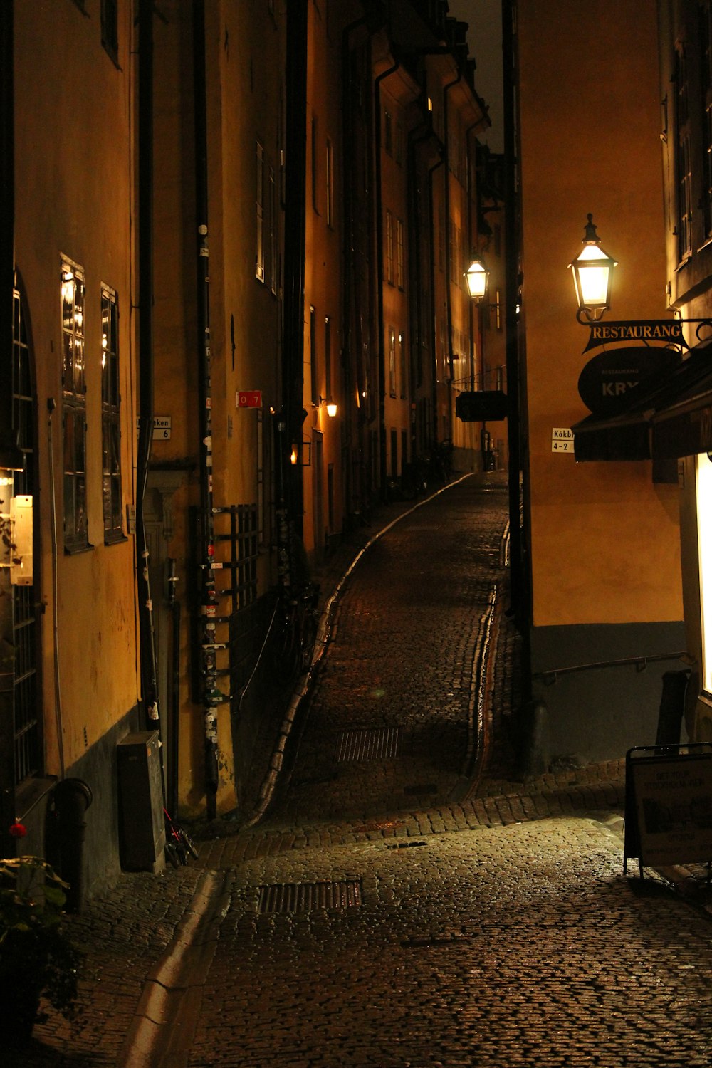 a dark alley way with a bench at night