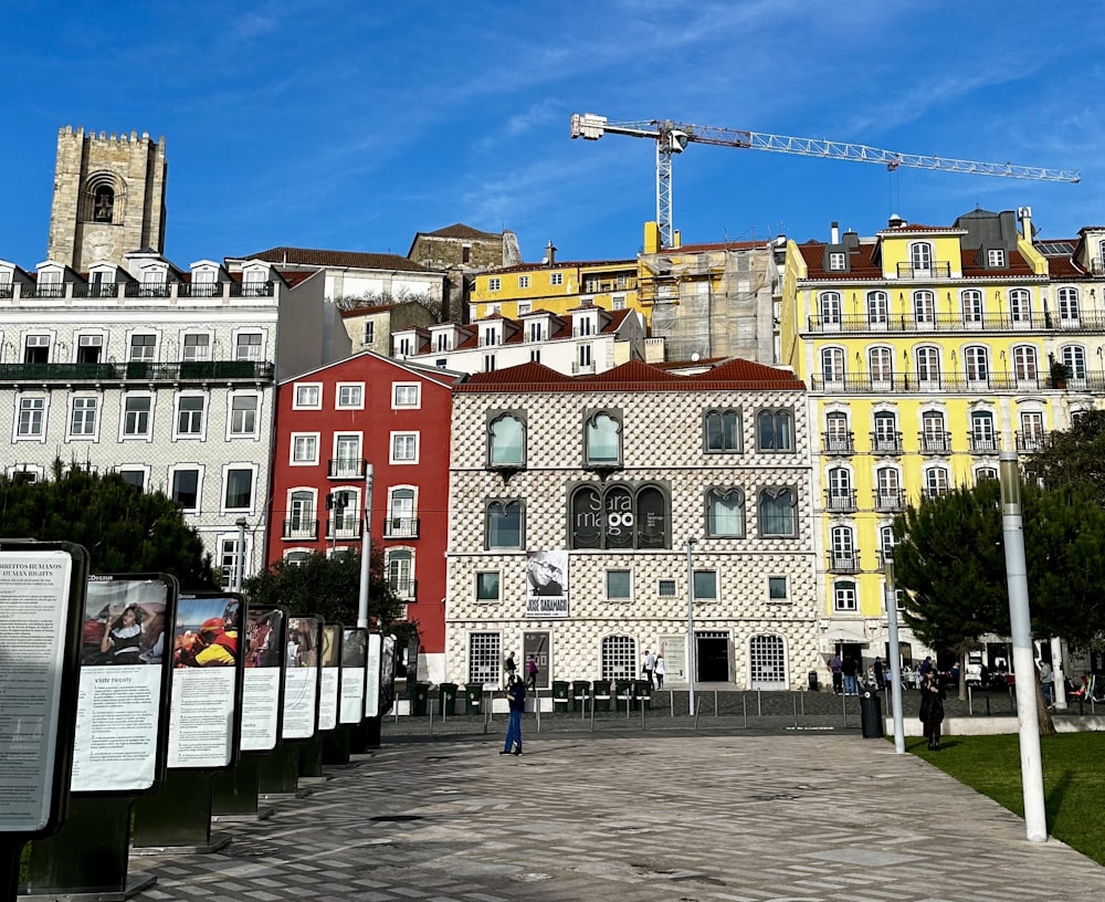 a group of buildings with a crane in the background