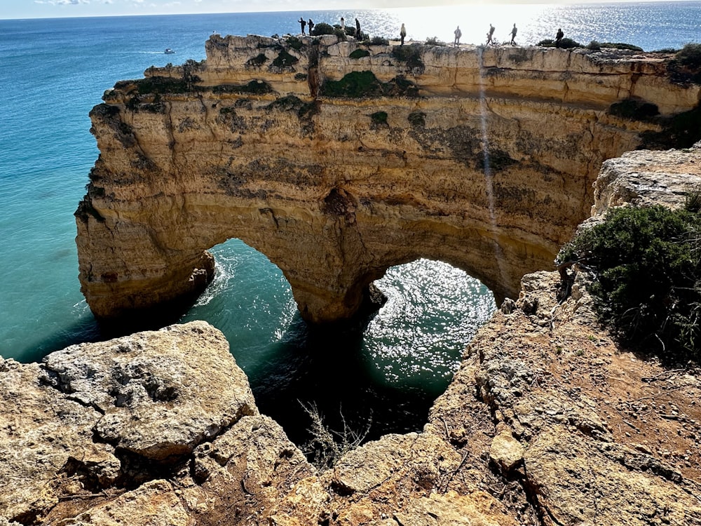 a rocky cliff overlooks a body of water