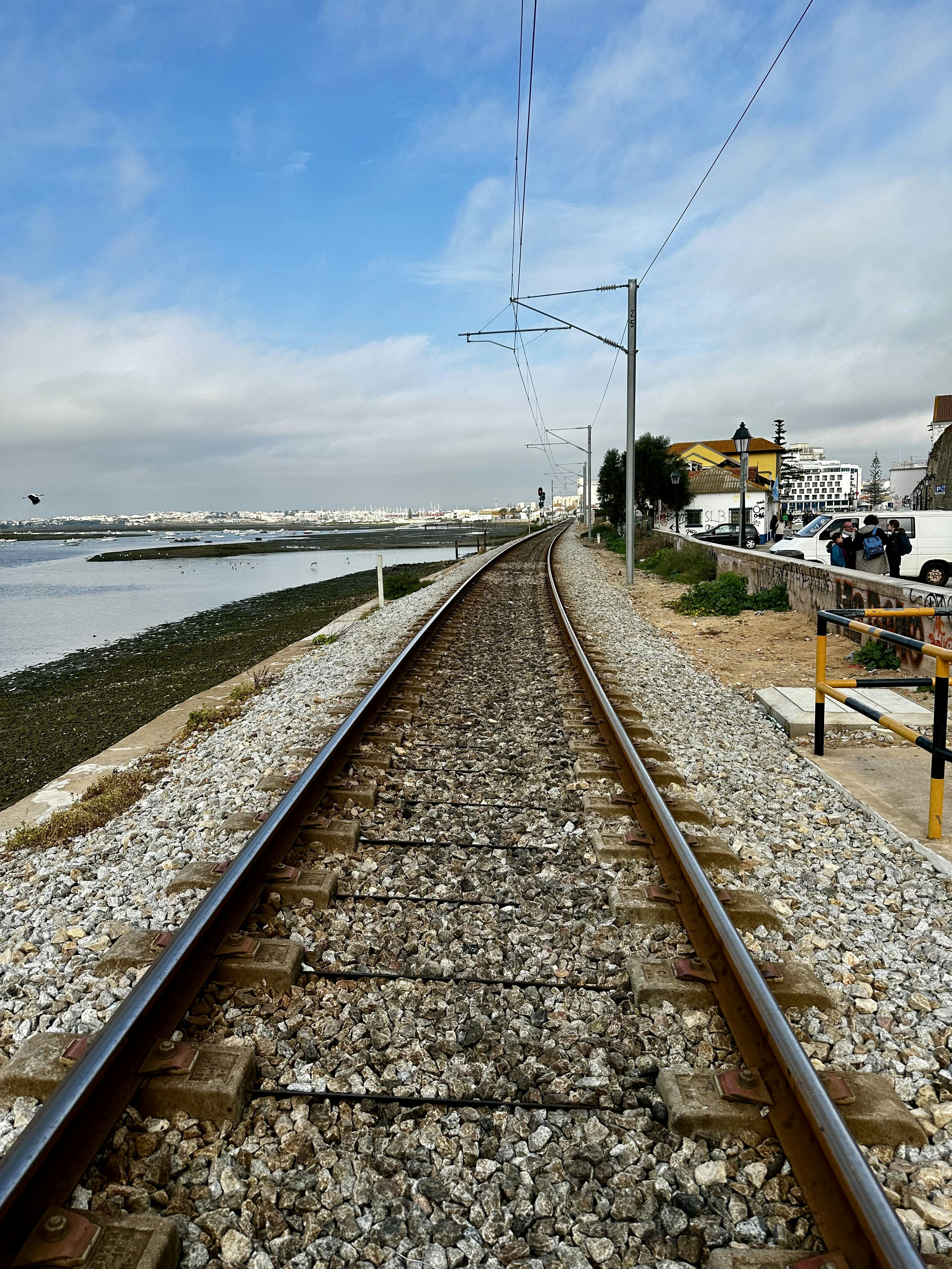 a train track with a view of a body of water