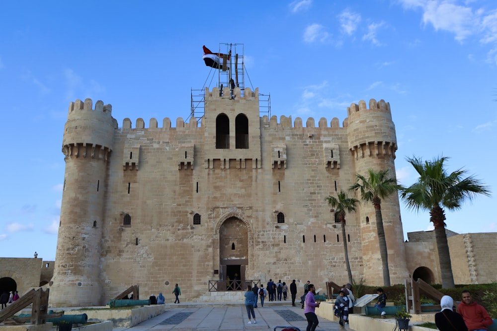 a group of people standing in front of a castle