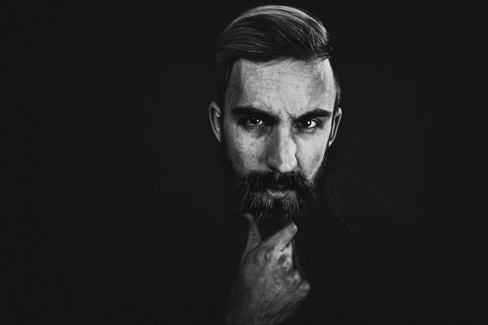 a black and white photo of a man with a beard
