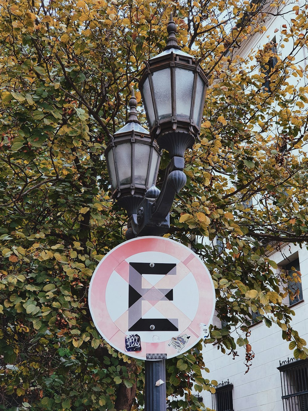 a lamp post with a street sign attached to it