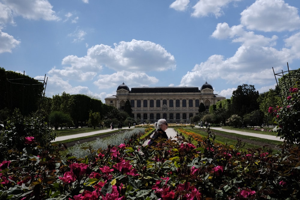 a view of a large building with a garden in front of it