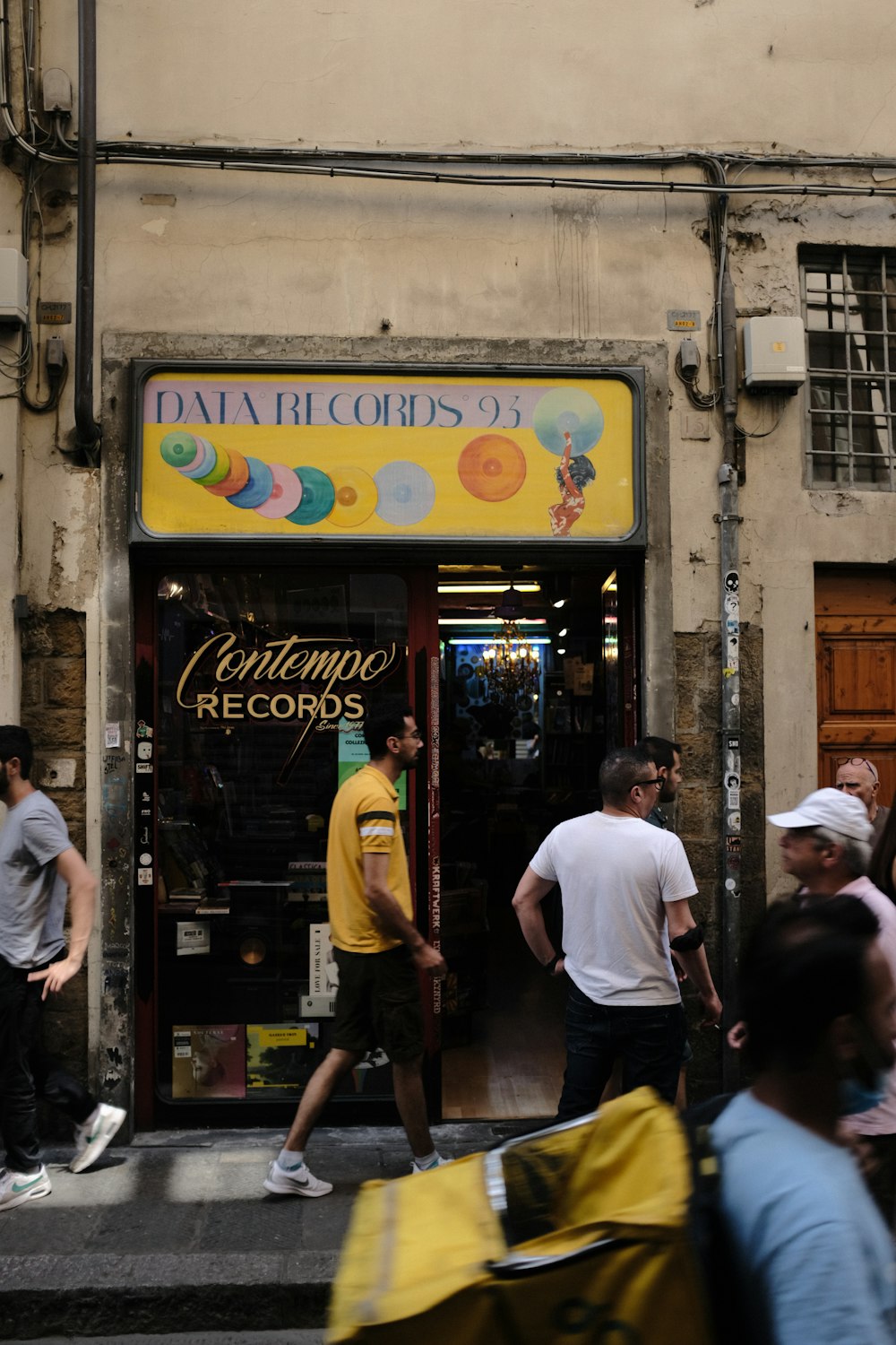 a group of people standing outside of a store