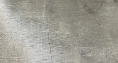a close up of a metal plate with a clock on it