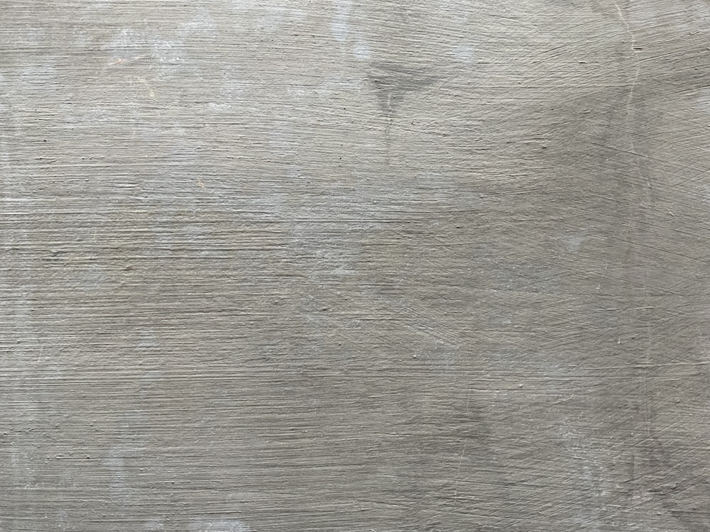a close up of a wooden surface with scratches