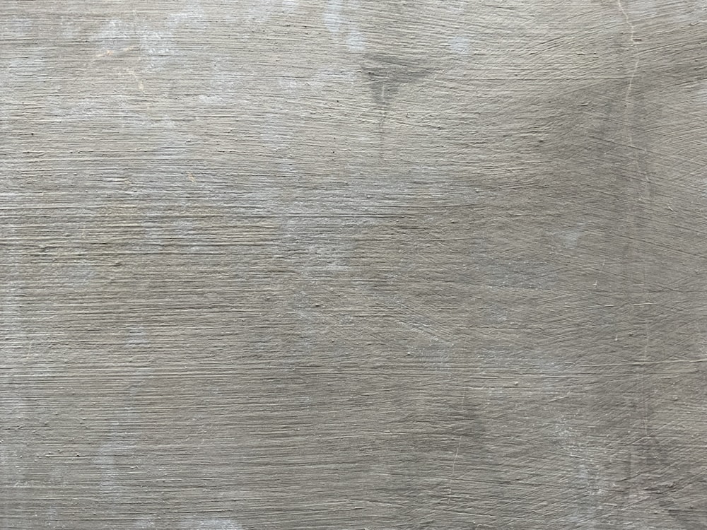 a close up of a wooden surface with scratches