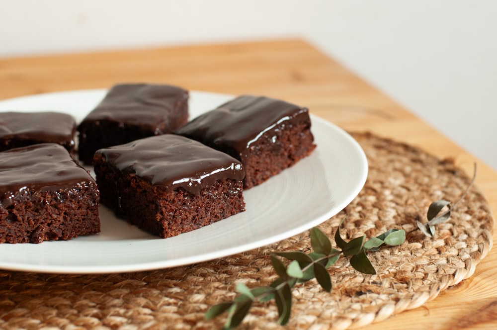 a white plate topped with brownies on top of a wooden table