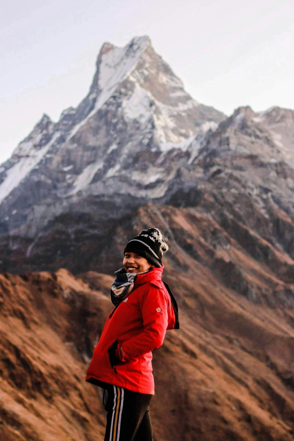 a man standing on top of a snow covered mountain