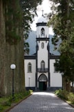 a white and black church with a clock tower