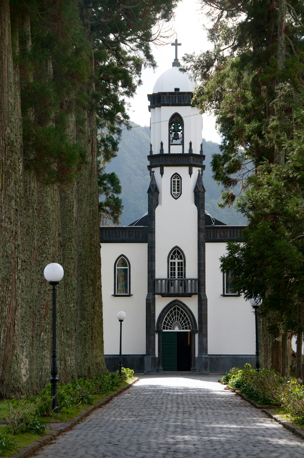 a white and black church with a clock tower