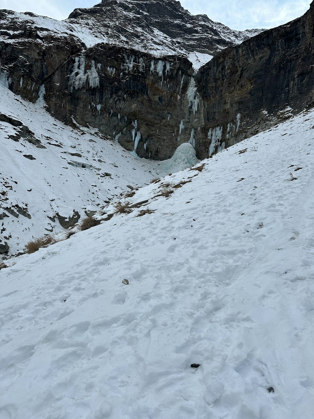 a man riding skis down a snow covered slope