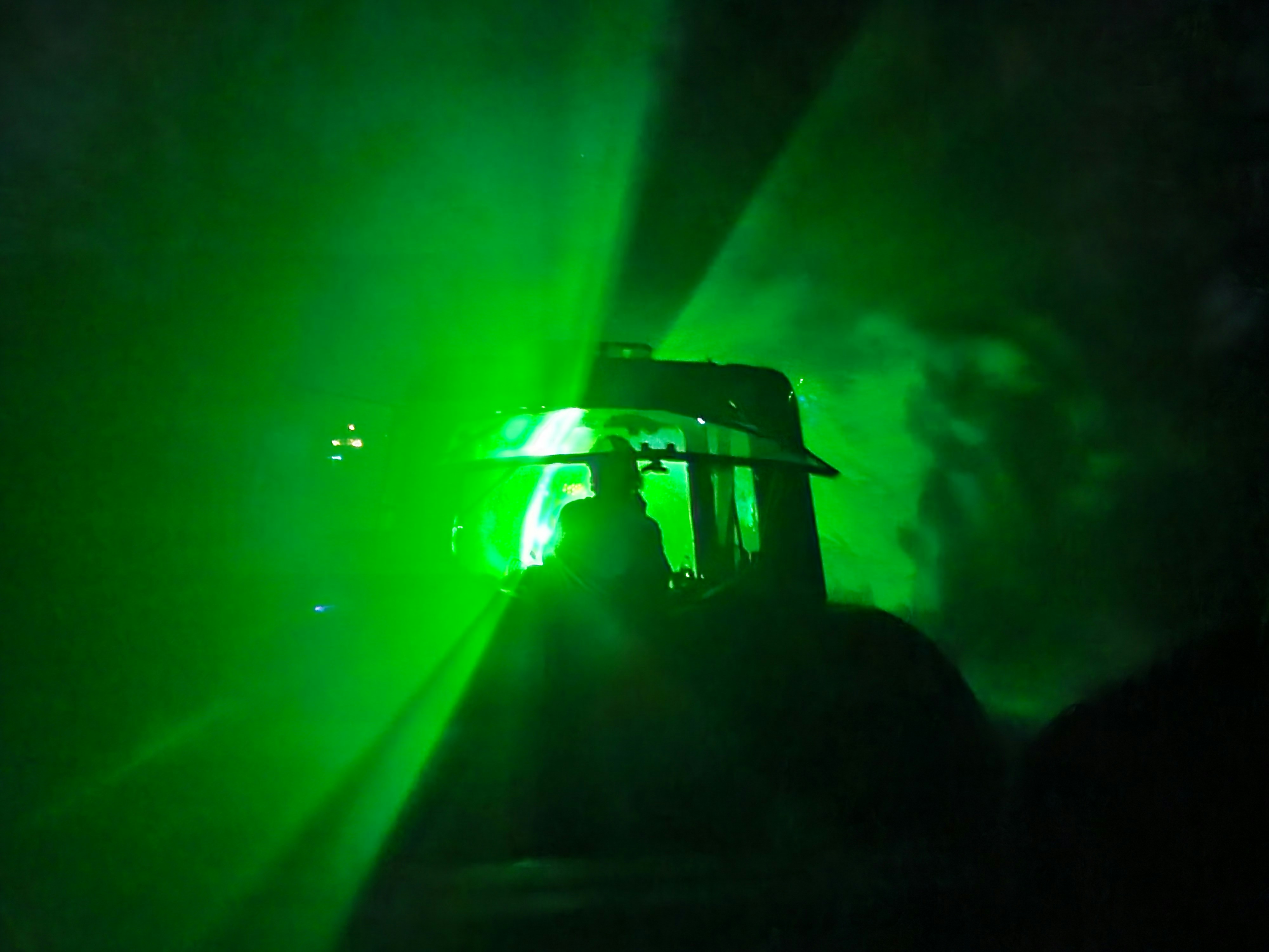 a green light shines on a dark stage