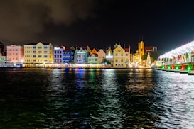 a night time view of a city with lights and buildings