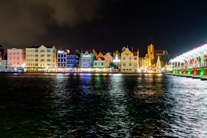 a night time view of a city with lights and buildings