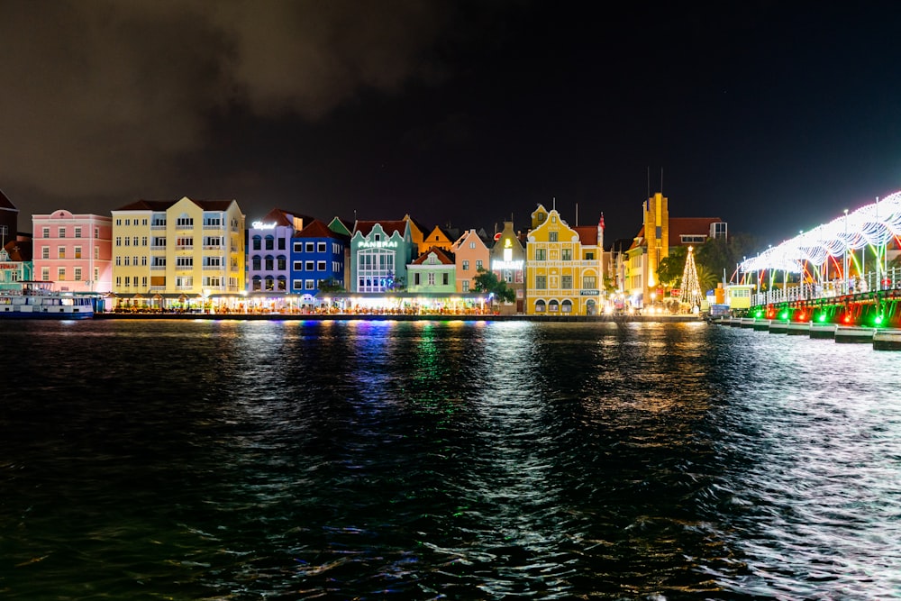 a night time view of a city with lights and buildings