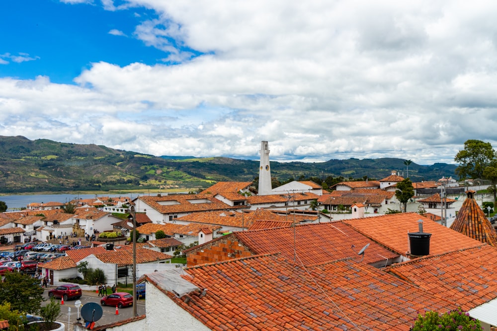 a view of a town with a lake and mountains in the background