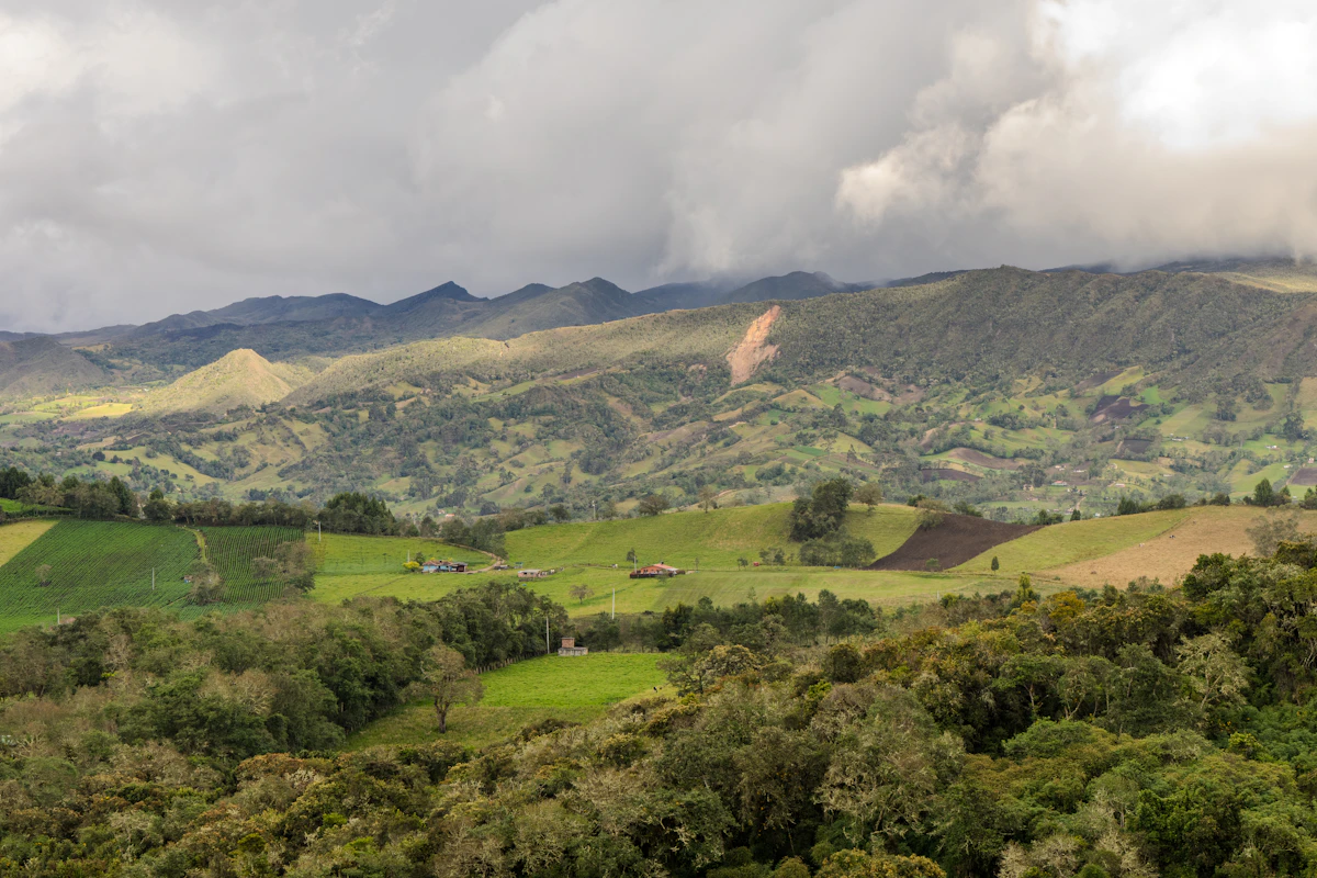 Paisaje rural verde con montañas y nubes en la región de Guatavita.