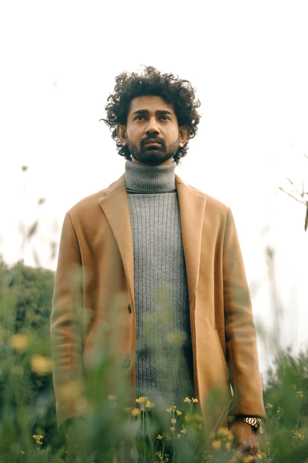 a man standing in a field of tall grass