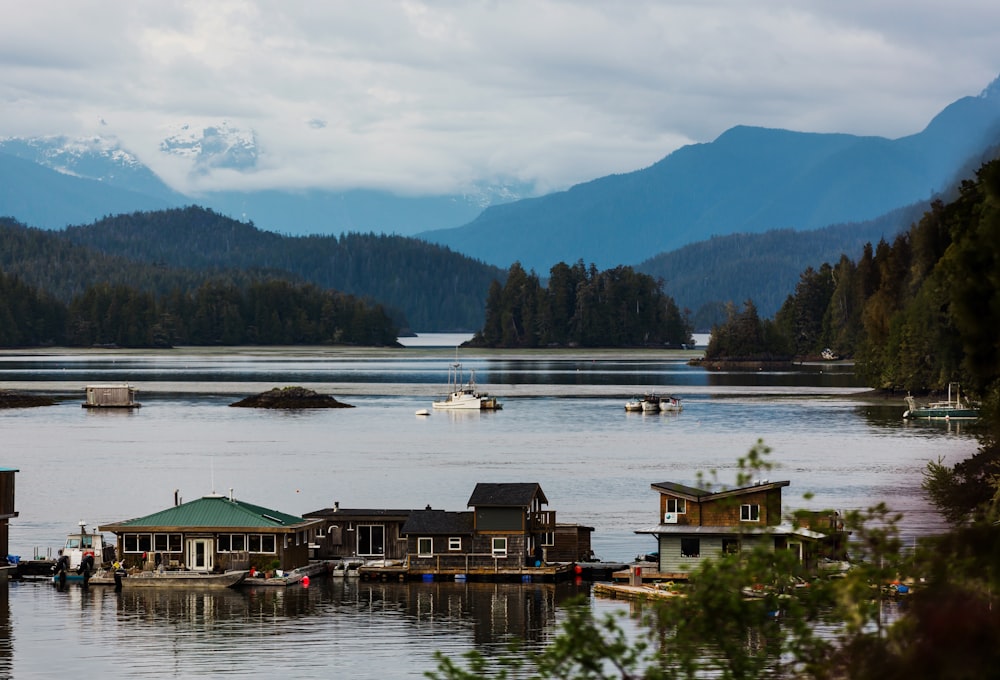 a body of water surrounded by mountains and houses