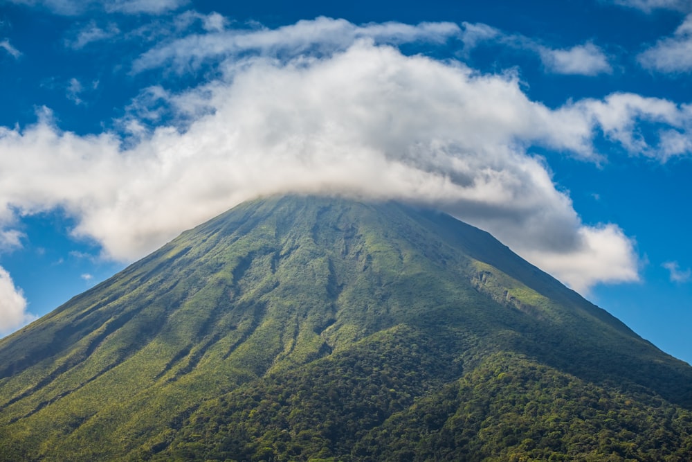 a very tall mountain with a cloud in the sky