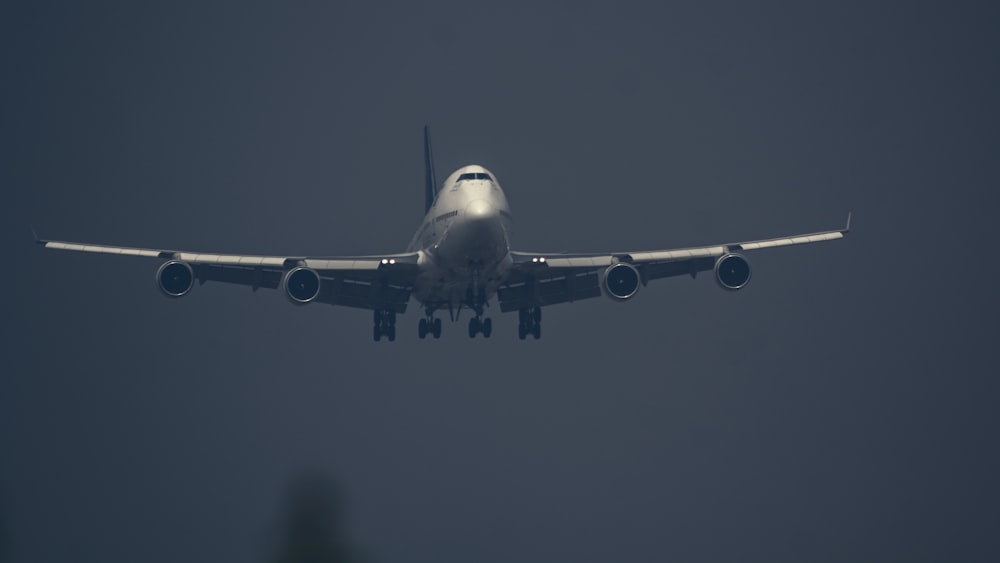 a large jetliner flying through a foggy sky