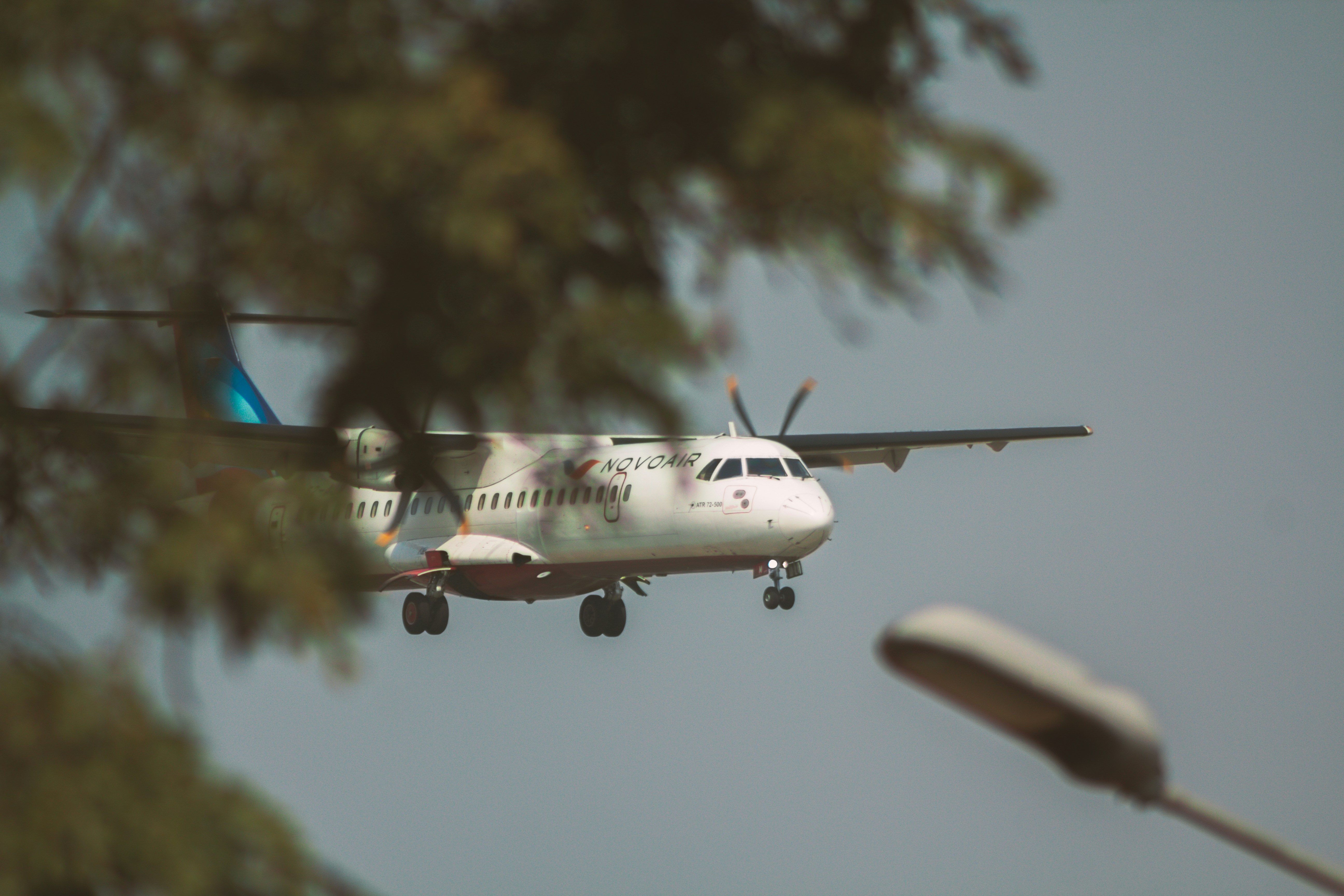 a plane is flying low to the ground, Novoair ATR 72-500 cinematic shot.