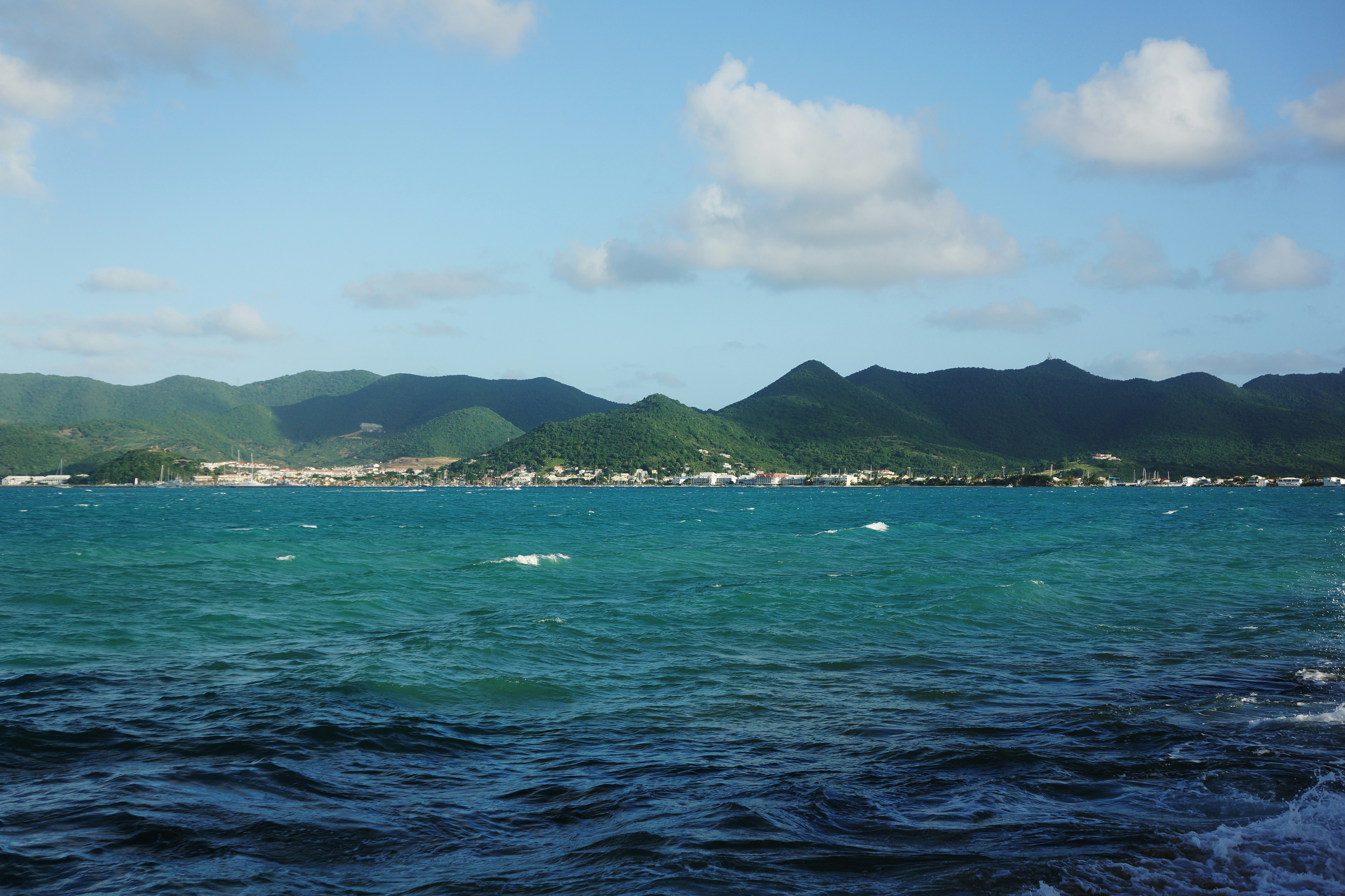 a body of water with mountains in the background, 