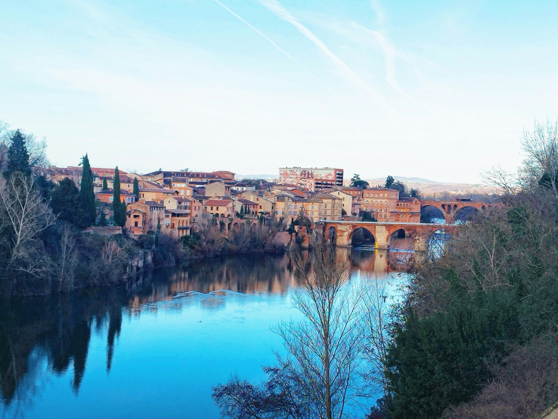 a river running through a city next to a bridge