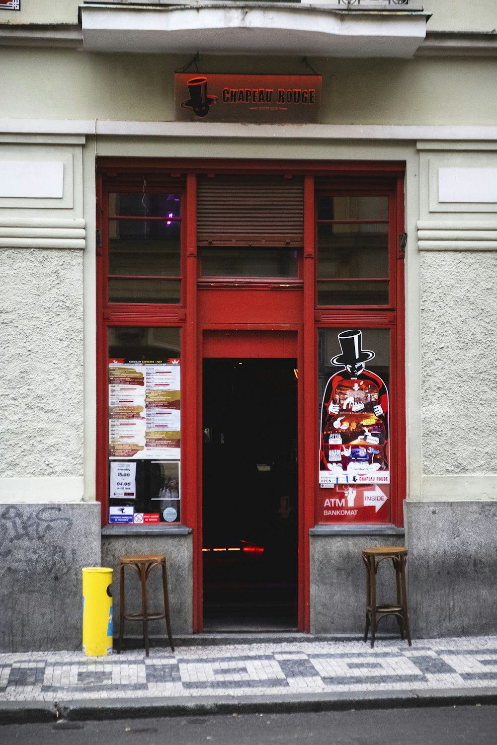 a store front with two chairs in front of it