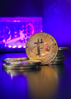 a stack of gold bitcoins sitting on top of a table