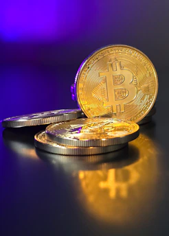 a pile of gold bitcoins sitting on top of a table