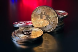 a pile of bitcoins sitting on top of a table