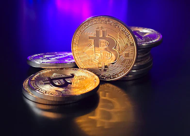a pile of bitcoins sitting on top of a table