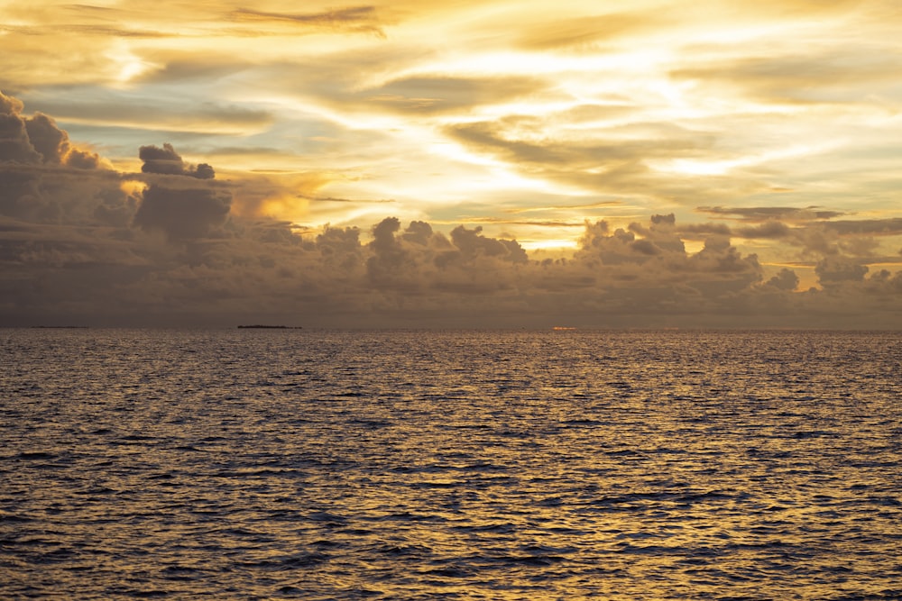 a large body of water under a cloudy sky