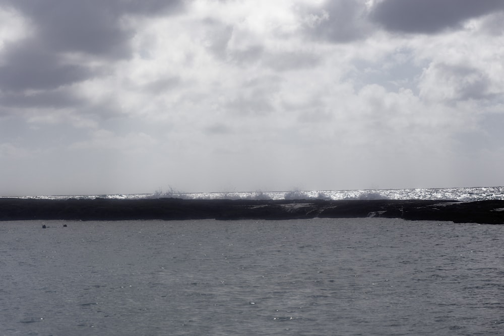 a large body of water with a sky background