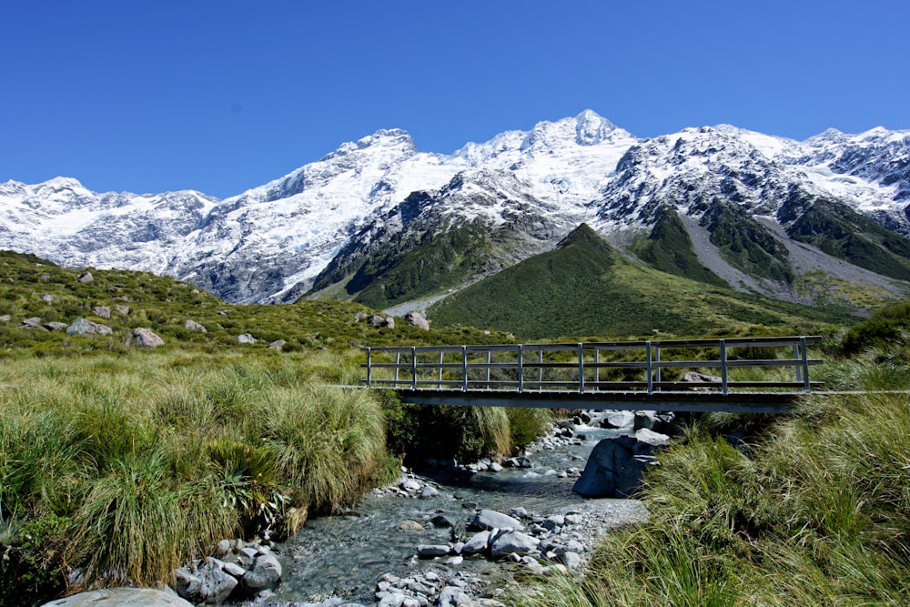 a bridge over a stream in the mountains