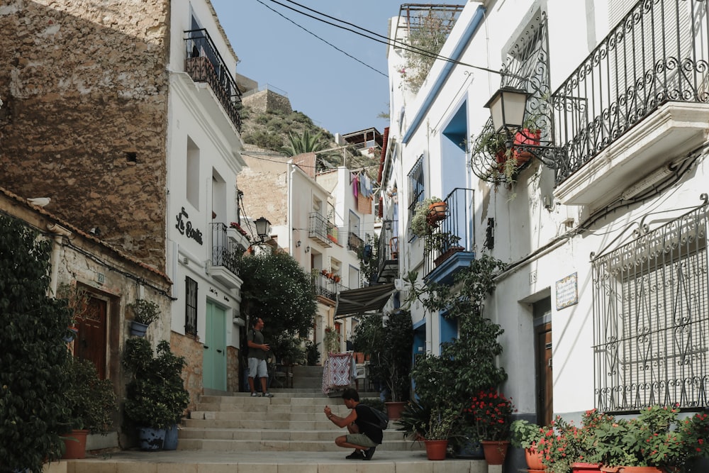 a person sitting on a set of steps in front of a building