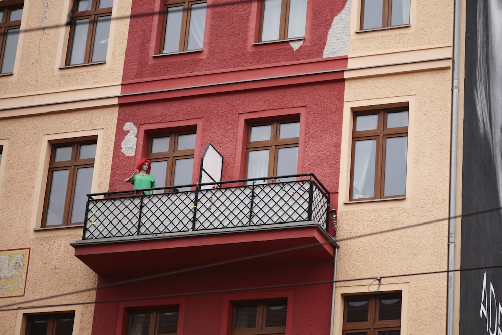 a man standing on a balcony of a building