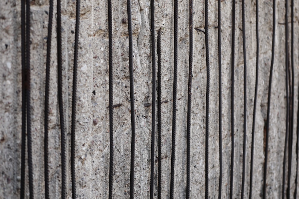 a close up of a metal fence on a concrete wall