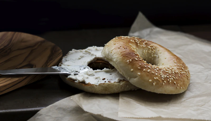 A bagel with a bite taken out of it