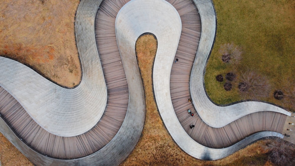 an aerial view of a curved walkway in a park