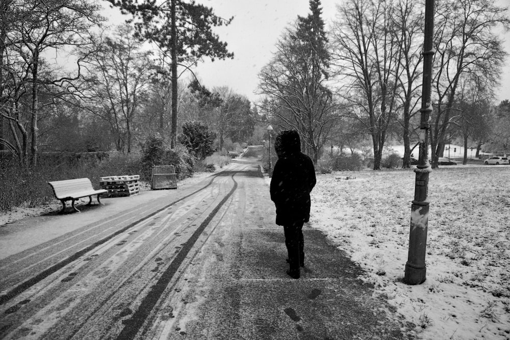 a person walking down a snow covered road