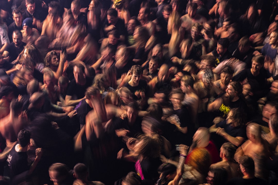 a large group of people in a crowd, A moshpit crowd at a heavy metal music concert