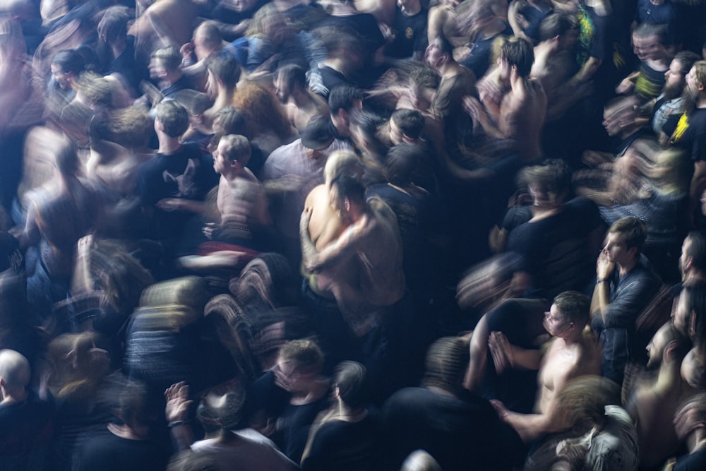 a crowd of people standing around each other