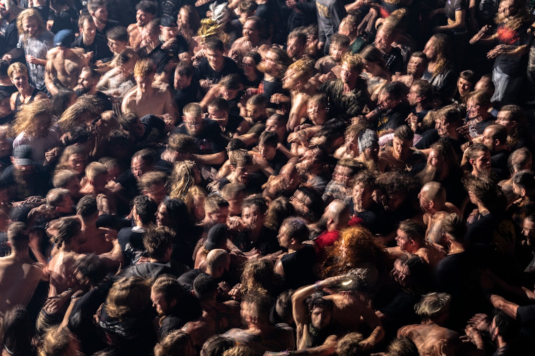 a large group of people in a crowd, A moshpit crowd at a heavy metal music concert