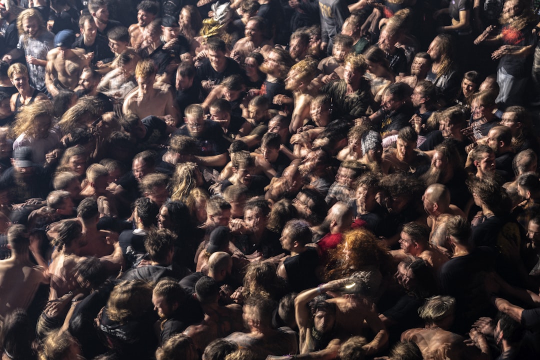 a large group of people in a crowd, A moshpit crowd at a heavy metal music concert