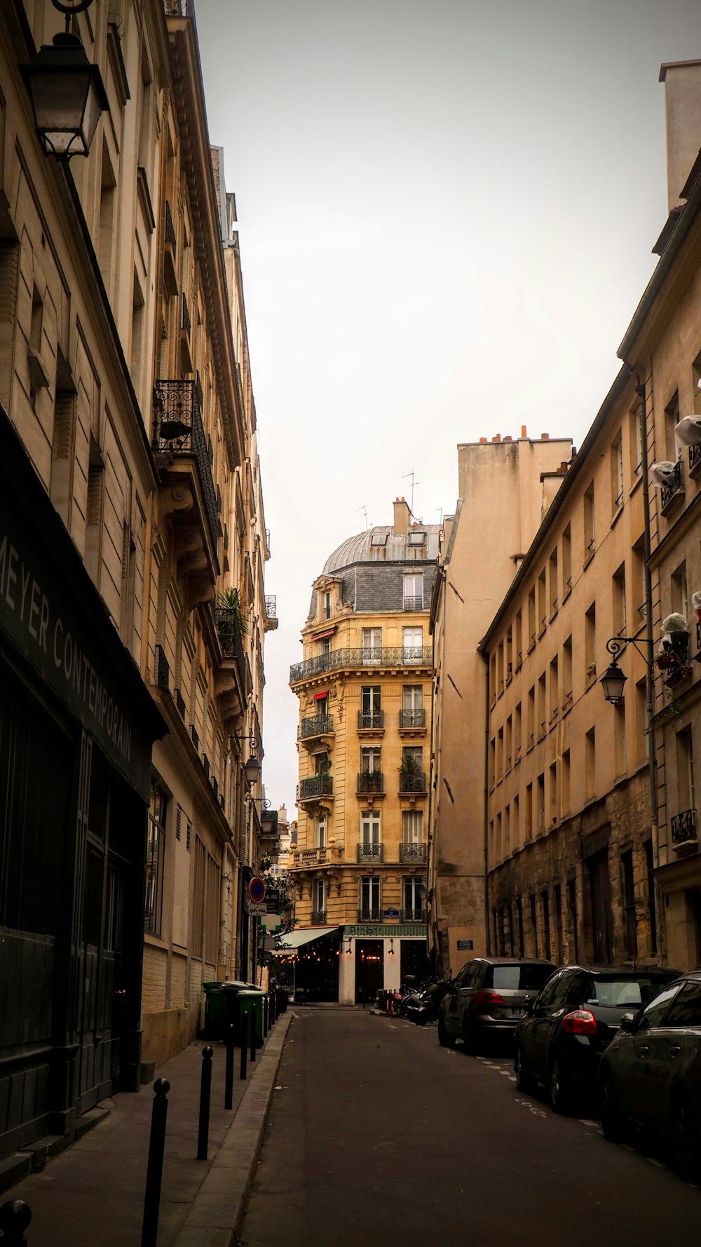 a narrow city street lined with tall buildings